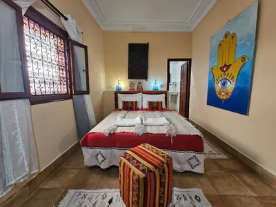 a bedroom with a large bed in a room at Riad Dar Rita in Ouarzazate