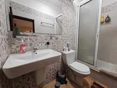 a bathroom with a sink and a toilet and a shower at Riad Dar Rita in Ouarzazate
