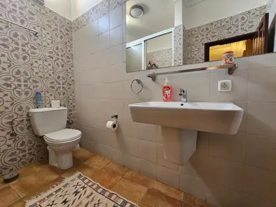 a bathroom with a sink and a toilet at Riad Dar Rita in Ouarzazate