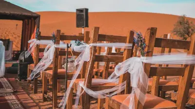 a set of tables in the middle of the desert at Camel Trips Luxury Camp in Merzouga