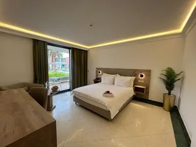 a hotel room with a bed and a large window at Hôtel Volubilis in Fès