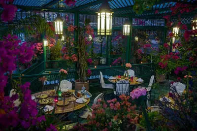 a rendering of a garden with tables and chairs and flowers at Riad La Maison Verte in Fès