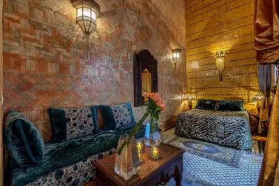 a living room with a couch and a table at Riad La Maison Verte in Fès