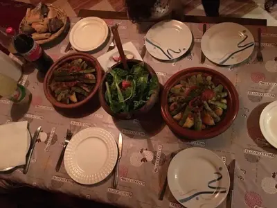 a table with plates and bowls of food on it at Chalet tizrag in Oukkainrdem