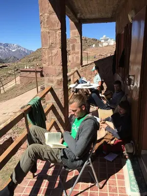 a group of people sitting in chairs with their laptops at Chalet tizrag in Oukkainrdem