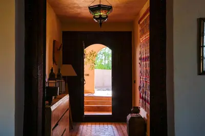 a hallway with an open door to a house at Dune House in Merzouga