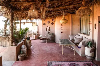 a living room with a couch and a table at Dune House in Merzouga