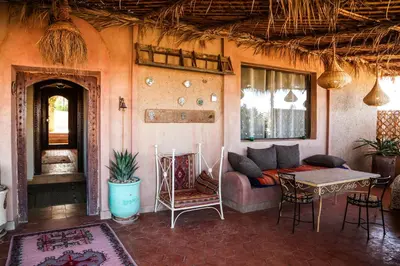 a living room with a couch and a table at Dune House in Merzouga