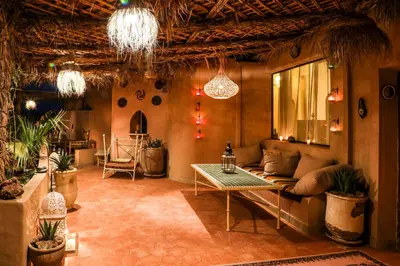a living room with a couch and a table at Dune House in Merzouga