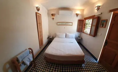 a bedroom with a large bed in a room at Dar Houdou in Fès