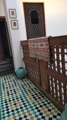 a room with a door and a checkered floor at Dar Houdou in Fès