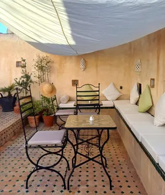 a living room with a couch and a table at Dar El Bali in Fès