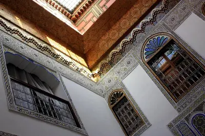 an ornate ceiling and windows in a mosque at Dar El Bali in Fès