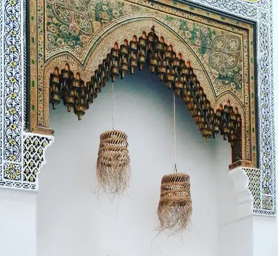 a room with two chandaliers hanging from a wall at Dar El Bali in Fès