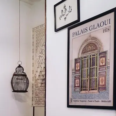 a wall with a picture and a bird cage on it at Dar El Bali in Fès