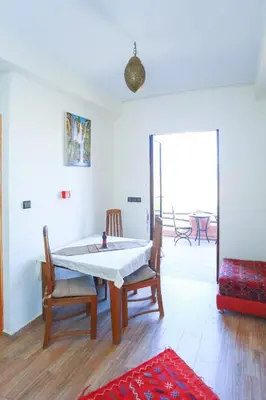 a room with a table and chairs and a window at Maison d'hôtes Tinwitchi in Azilal