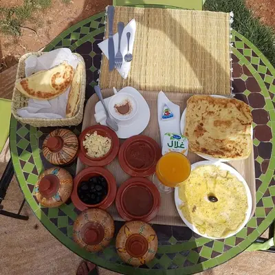a table with a bunch of food on it at Maison d'hôtes Tinwitchi in Azilal