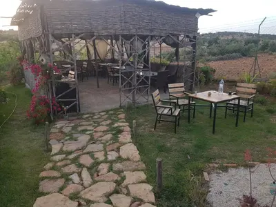 a group of tables and chairs under a gazebo at Maison d'hôtes Tinwitchi in Azilal