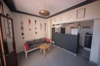 a living room with a couch and a table at Hotel Kasbah Ennakhile - Authentic Stay in Nkob in Nkob