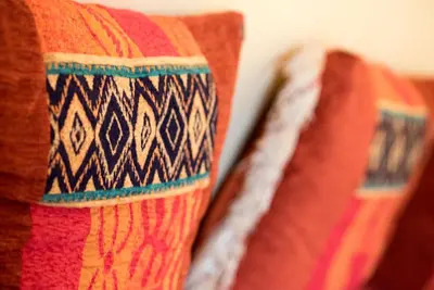 two colorful pillows sitting next to each other at Hôtel Rif in Meknès