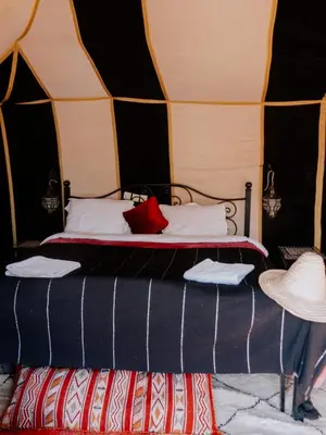 a bedroom with a bed in a tent at Asama Luxury Camp in Merzouga