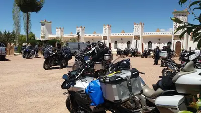 a group of motorcycles parked in front of a building at Ksar Timnay Hotel in Aguelmous