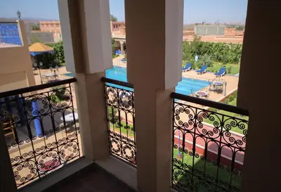 a balcony with a view of a swimming pool at Ksar Ben Youssef in Ouarzazate