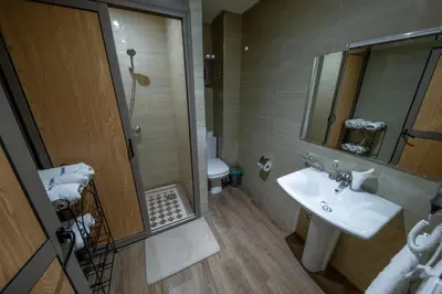 a bathroom with a sink and a toilet and a mirror at Ksar Ben Youssef in Ouarzazate