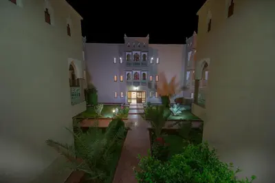 a large building with a lit up building at night at Ksar Ben Youssef in Ouarzazate