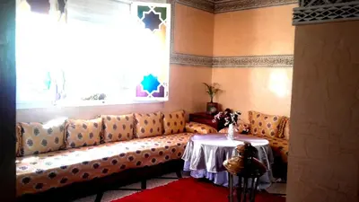 a living room with a couch and a table at Riad Dar Zidane in Meknès