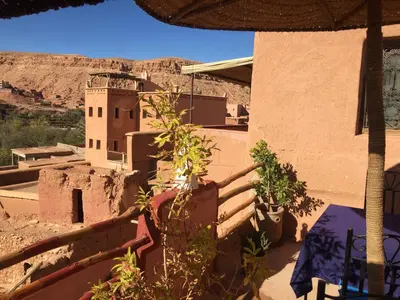 a view of the desert from a house with a tower at Kasbah du Peintre in Aït Ben Haddou