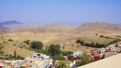 a view of a small village in the mountains at Hotel Ain Leuh in Aïn Leuh