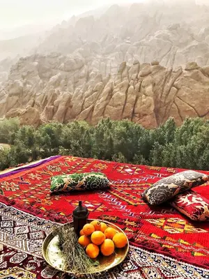 a table with a plate of oranges on top at Monkey Fingers House by Fatima mellal in Tinerhir