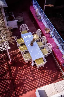 a table and chairs sitting on a patio at Monkey Fingers House by Fatima mellal in Tinerhir