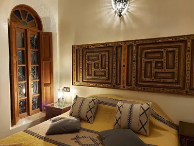 a bedroom with a bed with pillows on it at Dar Hayati in Fès