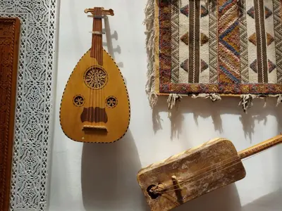 a guitar and a wooden box on a wall at Dar Hayati in Fès