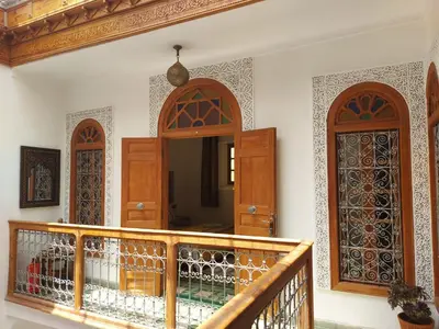 a room with wooden doors and a balcony at Dar Hayati in Fès
