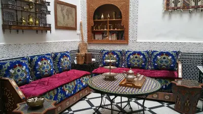 a living room with a couch and a table at Dar Hayati in Fès