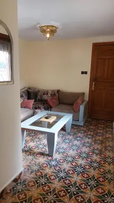 a living room with a couch and a coffee table at Dar Hayati in Fès