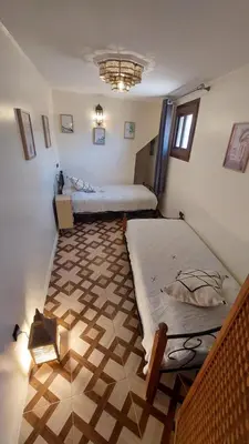 a room with two beds and a floor at Dar Hayati in Fès