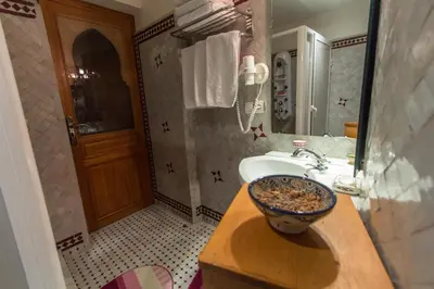 a bathroom with a sink and a bowl on a counter at Riad Raouia HAMMAM & SPA in Fès