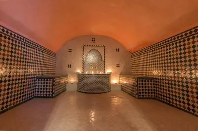 a room with a tiled wall with a fountain in it at Riad Raouia HAMMAM & SPA in Fès