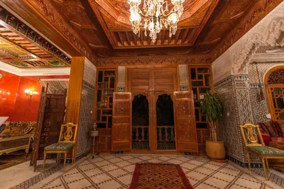 a living room with a chandelier and a large room with a room at Riad Raouia HAMMAM & SPA in Fès