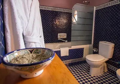 a bathroom with a toilet and a bowl on a table at Riad Raouia HAMMAM & SPA in Fès