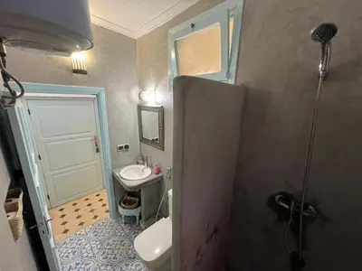 a small bathroom with a sink and a toilet at Maison d'hôtes Dar Farhana in Ouarzazate