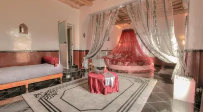 a living room with a couch and a table at Jardin de la source in Aït Yous
