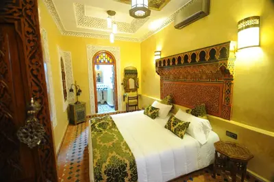 a bedroom with a large bed in a room at Riad Mama H&K in Meknès