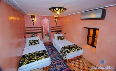a bedroom with two beds in a room at Riad Mama H&K in Meknès