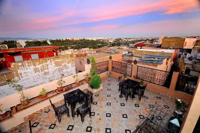 an aerial view of a city with tables on a balcony at Riad Mama H&K in Meknès