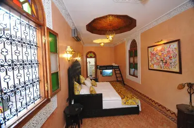 a bedroom with a bed and a window at Riad Mama H&K in Meknès